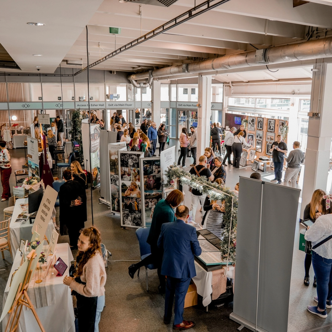 Visitors browsing supplier stands at a Main Event Wedding Show in Essex